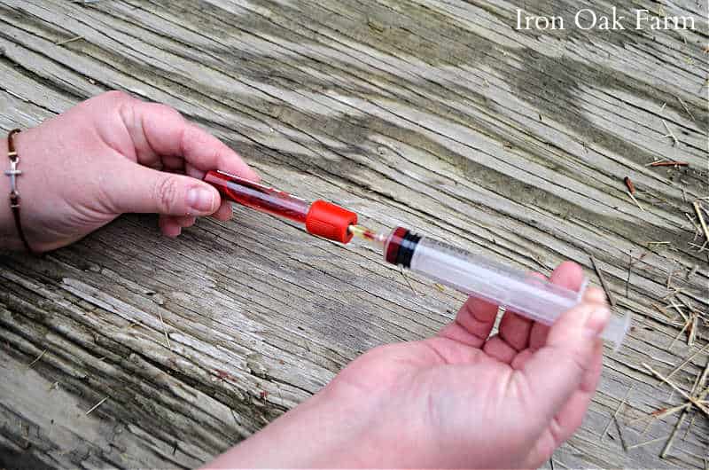 insert needle into red cap vial